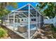 Large screened in pool with new enclosure featuring the rear facade of the home at 10314 Lake Carroll Way, Tampa, FL 33618