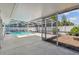 Covered patio with large pool and enclosure, landscaped yard with privacy fence, and lots of room to relax at 10314 Lake Carroll Way, Tampa, FL 33618