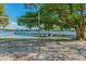 Sand volleyball court with shade trees by the lake at 10314 Lake Carroll Way, Tampa, FL 33618