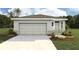 Charming single-story home featuring a two-car garage, neutral paint, and landscaping at 10583 Dusty Boot Rd, Land O Lakes, FL 34638
