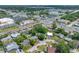 Aerial view of the home in its neighborhood surrounded by local shops and established trees at 10821 101St Ave, Seminole, FL 33772