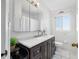A clean bathroom with a dark vanity, white countertops, and a large mirror at 10821 101St Ave, Seminole, FL 33772