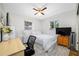 This bedroom is bright with natural light, and features a ceiling fan and desk at 10821 101St Ave, Seminole, FL 33772
