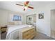 This bedroom features a large window, soft neutral colors, and a mirrored closet at 10821 101St Ave, Seminole, FL 33772