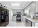 Clean kitchen with gray cabinets, modern appliances, and plenty of counter space at 10821 101St Ave, Seminole, FL 33772