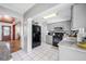 A well-lit kitchen featuring white tile floors, granite countertops and updated appliances at 10821 101St Ave, Seminole, FL 33772