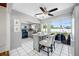 Well-lit kitchen featuring gray cabinets, granite counters, and sliding doors to the outdoor patio at 10821 101St Ave, Seminole, FL 33772