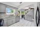This bright kitchen offers gray cabinets, stainless steel appliances, and a view to the backyard at 10821 101St Ave, Seminole, FL 33772