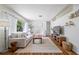 Comfortable living room with hardwood floors, bright white sofas, and natural light at 10821 101St Ave, Seminole, FL 33772