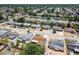 An aerial perspective of a residential neighborhood featuring cozy homes, green trees, and easy access to suburban amenities at 1153 Honor Dr, Holiday, FL 34690