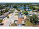 Aerial view of neighborhood homes, landscaping, and pond at 1153 Honor Dr, Holiday, FL 34690