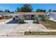 Charming single-story home with brick accents, a carport, and a well-maintained front yard at 1153 Honor Dr, Holiday, FL 34690