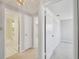 A hallway shows doorways to other rooms, including a bathroom with a shower/tub combination at 1153 Honor Dr, Holiday, FL 34690