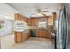 This neutral kitchen offers tile floors, light wood cabinets, stainless appliances, and ample counter space at 1153 Honor Dr, Holiday, FL 34690