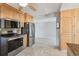Functional kitchen featuring stainless steel appliances, granite countertops, and plentiful wooden cabinetry at 1153 Honor Dr, Holiday, FL 34690
