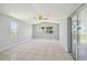 Bright living room with tile flooring, fan, and sliding glass doors providing access to the outdoors at 1153 Honor Dr, Holiday, FL 34690