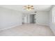 Neutral room features tile floors and neutral paint and opens to other areas of the house through open doorways at 1153 Honor Dr, Holiday, FL 34690