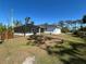 A spacious backyard showcases the home's screened-in pool and patio, with a fence surrounding the perimeter at 12021 Coleman Ave, Port Charlotte, FL 33981