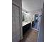 Bathroom featuring a double sink vanity, an LED mirror, wood-look tile, and a walk-in shower at 12021 Coleman Ave, Port Charlotte, FL 33981