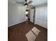 This bedroom includes wood-look tile flooring, closet, ceiling fan, and neutral color paint at 12021 Coleman Ave, Port Charlotte, FL 33981