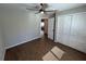 This bedroom includes wood-look tile flooring, closet, ceiling fan, and neutral color paint at 12021 Coleman Ave, Port Charlotte, FL 33981