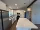 Modern kitchen features stainless steel appliances, a large island and a sink overlooking the window at 12021 Coleman Ave, Port Charlotte, FL 33981