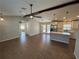 Bright kitchen with white cabinets, a stylish island, and a view into the living area featuring tile floors at 12021 Coleman Ave, Port Charlotte, FL 33981