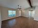 Spacious living area with tile floors, a beamed ceiling, and access to other rooms in the house at 12021 Coleman Ave, Port Charlotte, FL 33981