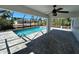 A screened-in in-ground pool is surrounded by pavers and ample entertaining space at 12021 Coleman Ave, Port Charlotte, FL 33981