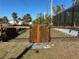 A charming wooden gate leads to a fenced-in pool area, adding a touch of rustic appeal at 12021 Coleman Ave, Port Charlotte, FL 33981