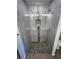Shower features decorative stone accents, tile walls and flooring, and a glass door at 12021 Coleman Ave, Port Charlotte, FL 33981