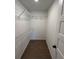Walk-in closet featuring wire shelving and wood-look tile flooring at 12021 Coleman Ave, Port Charlotte, FL 33981