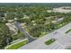 Aerial view showcases townhomes with lush surrounding trees, with roadways and suburban streetscapes at 1236 Abbey Crescent Ln, Clearwater, FL 33759
