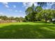 Expansive green backyard features a well-kept lawn and a privacy fence at 1236 Abbey Crescent Ln, Clearwater, FL 33759