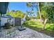 Paver patio with shade from mature trees overlooking the fenced backyard, perfect for relaxing at 1236 Abbey Crescent Ln, Clearwater, FL 33759
