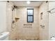 An accessible bathroom features tiled walls, mosaic floors, safety bars, and a rainfall shower head at 1236 Abbey Crescent Ln, Clearwater, FL 33759