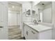 A stylish bathroom vanity features a white countertop, modern faucet, and decorative mirrors above the sink at 1236 Abbey Crescent Ln, Clearwater, FL 33759