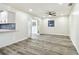 Bright, open living space featuring stylish floors, white walls, and double doors to the outside at 1236 Abbey Crescent Ln, Clearwater, FL 33759
