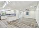 Open-concept living room connected to the kitchen and featuring new floors at 1236 Abbey Crescent Ln, Clearwater, FL 33759