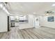 Bright and airy living room open to the modern kitchen with new floors at 1236 Abbey Crescent Ln, Clearwater, FL 33759