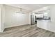 Open floor plan with light gray floors, modern light fixtures, and stainless steel kitchen appliances at 1236 Abbey Crescent Ln, Clearwater, FL 33759
