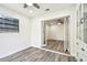 A bright room featuring wood-look flooring, built in cabinets, and french doors with view to adjacent room at 1236 Abbey Crescent Ln, Clearwater, FL 33759