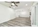 Bright living room featuring gray flooring, a ceiling fan and an adjacent dining area at 1236 Abbey Crescent Ln, Clearwater, FL 33759