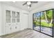 A living room features built-in cabinets and sliding glass doors to a patio at 1236 Abbey Crescent Ln, Clearwater, FL 33759