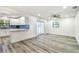 Open-concept living room connected to the kitchen features new floors at 1236 Abbey Crescent Ln, Clearwater, FL 33759