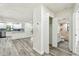 Open-concept living space with modern floors, white walls, and a view of the updated bathroom at 1236 Abbey Crescent Ln, Clearwater, FL 33759