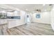 Open-concept living space featuring a modern kitchen with white cabinets and stylish floors at 1236 Abbey Crescent Ln, Clearwater, FL 33759