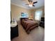 Cozy bedroom with ceiling fan and large window offering plenty of natural light at 12619 50Th E Ct, Parrish, FL 34219