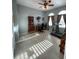 Bright home office features large windows, ceiling fan, and desk for a comfortable work environment at 12619 50Th E Ct, Parrish, FL 34219