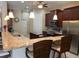 Well-equipped kitchen with granite countertops, stainless steel appliances, and bar seating at 12619 50Th E Ct, Parrish, FL 34219